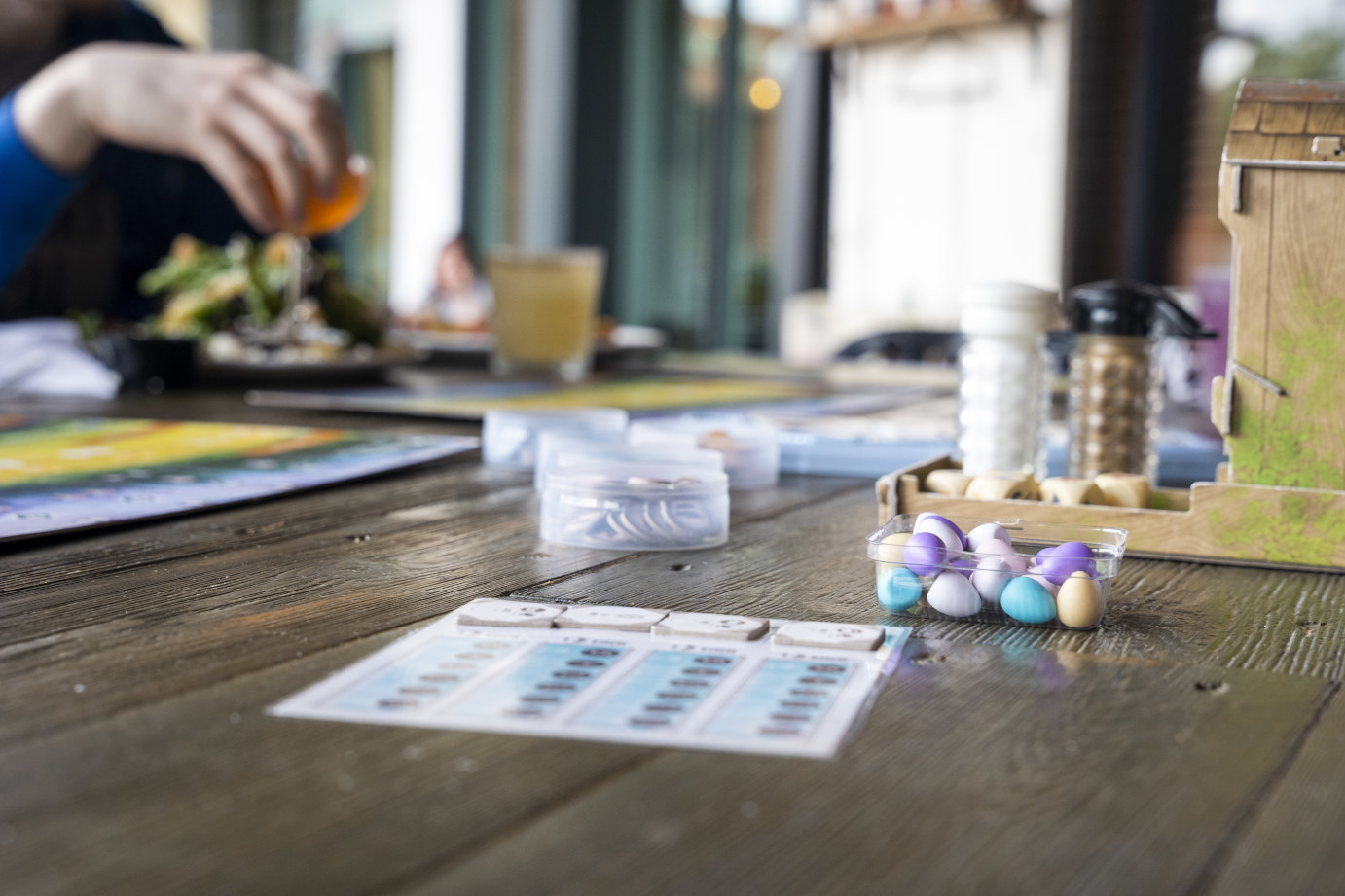 Exterior, guests dining and having fun with a board game